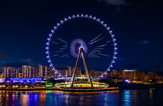 Ain Dubai observation wheel glowing on Bluewaters Island seen from a Dubai Marina dhow cruise