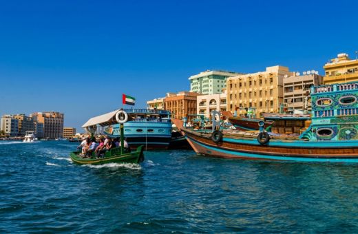 Deira old Dubai skyline and heritage buildings along Dubai Creek at night